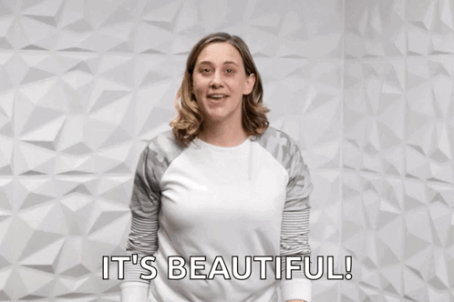 A Woman Pointing At The Camera With The Words You Rock It 'S Beautiful Behind Her GIF