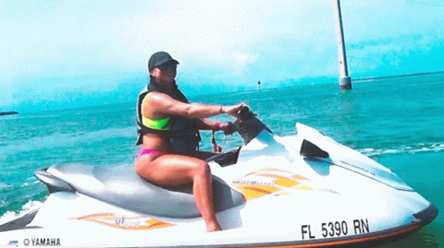 A Woman Riding A Yamaha Jet Ski In The Ocean GIF