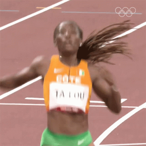a woman running on a track with the name ta lou on her jersey