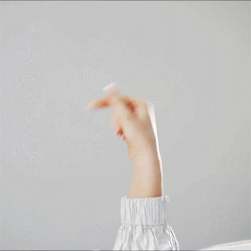 A Woman 'S Arm Is Shown With A White Sleeve And A White Background GIF