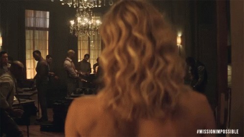 A Woman 'S Back Is Shown In A Mission Impossible Movie GIF