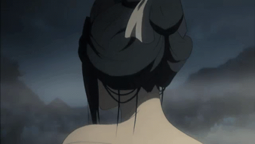 A Woman 'S Back Is Shown With A Bun And A Feather In Her Hair GIF