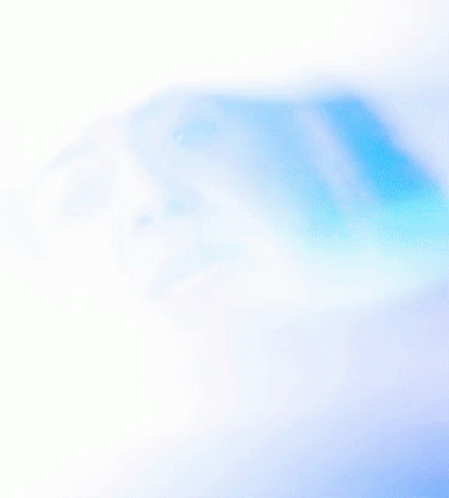 A Woman 'S Face Is Partially Obscured By A Blue Light GIF
