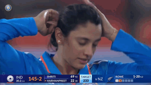 A Woman 'S Face Is Shown On A Television Screen During A Cricket Match Between India And Nz GIF