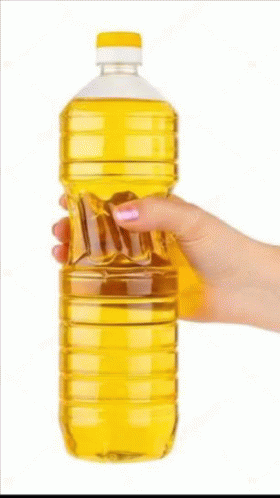 A Woman 'S Hand Is Holding A Bottle Of Oil . GIF