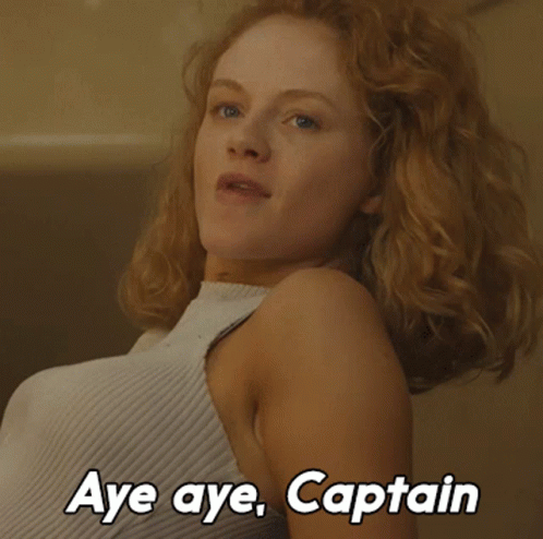 A Woman Says Aye Aye Captain In A White Shirt GIF