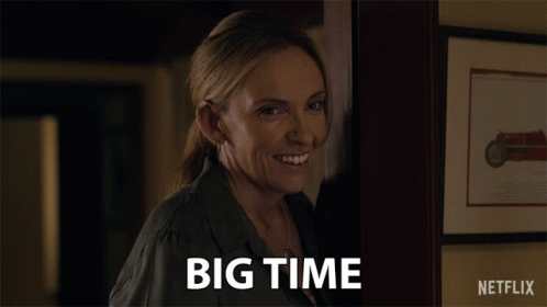 A Woman Says Big Time In Front Of A Picture Of A Motorcycle GIF