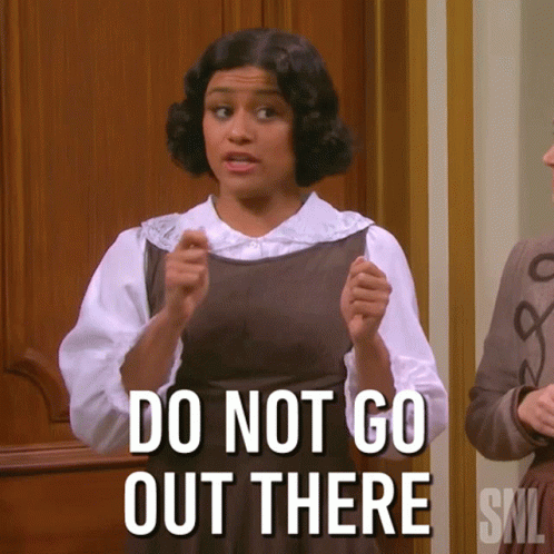 A Woman Says " Do Not Go Out There " While Standing In Front Of A Door GIF