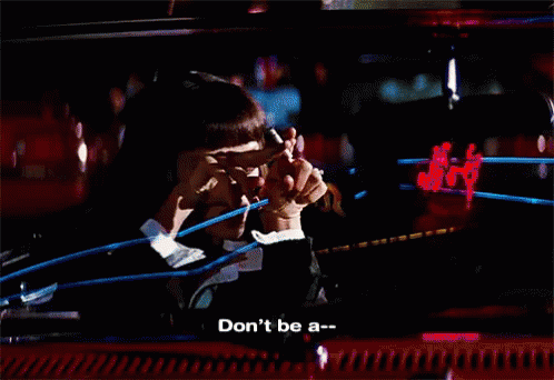 A Woman Says " Don 'T Be A " In Front Of A Blurry Background GIF