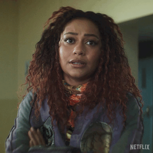 A Woman Says Everyone Has Skeletons In Front Of A Netflix Logo GIF