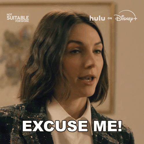 A Woman Says " Excuse Me " In Front Of A Hulu Logo GIF