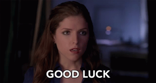 A Woman Says " Good Luck " In Front Of A Dark Background GIF