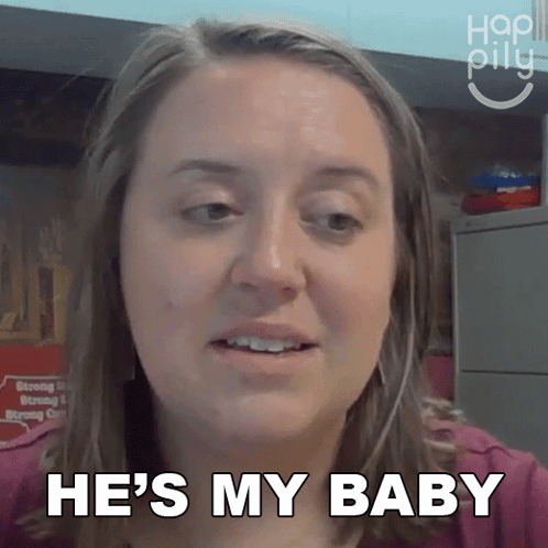 A Woman Says He 'S My Baby In Front Of A Sign GIF