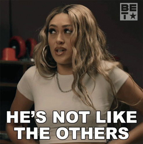 A Woman Says " He 'S Not Like The Others " While Wearing Hoop Earrings GIF
