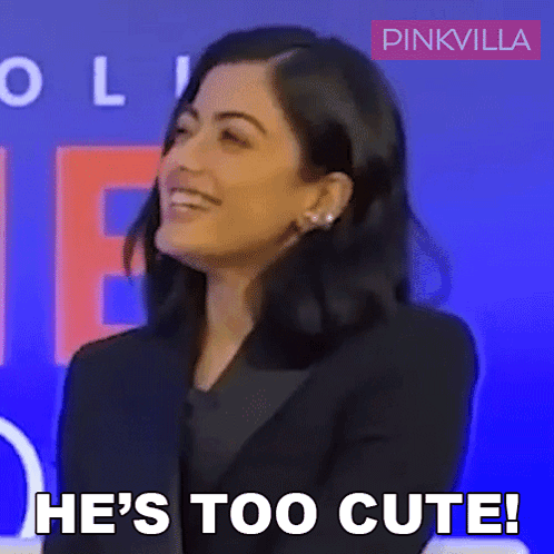 A Woman Says He 'S Too Cute In Front Of A Blue Background GIF