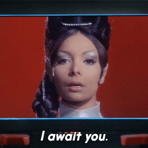 A Woman Says " I Await You " On A Red Background GIF