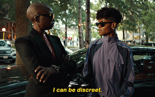A Woman Says I Can Be Discreet While Standing Next To Another Woman In Front Of A Car GIF