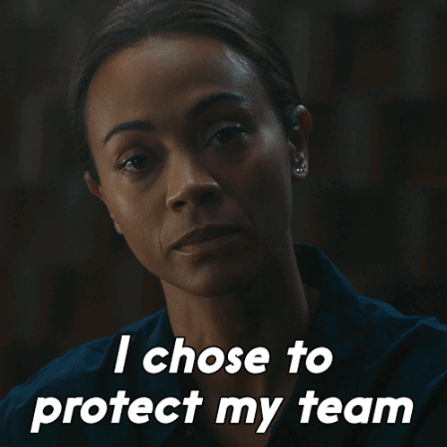 A Woman Says " I Chose To Protect My Team " In A Dark Room GIF