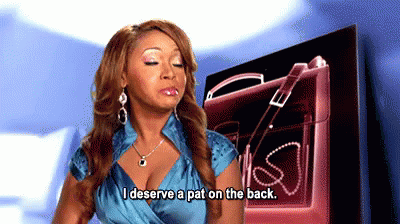 A Woman Says I Deserve A Pat On The Back In Front Of A Pink Purse GIF