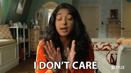 A Woman Says I Don 'T Care In Front Of A Couch GIF