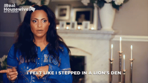 A Woman Says " I Felt Like I Stepped In A Lion 'S Den " In Front Of A Fireplace GIF