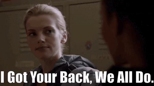 A Woman Says " I Got Your Back We All Do " In Front Of A Locker GIF
