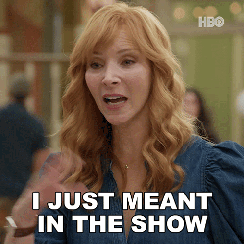 A Woman Says " I Just Meant In The Show " While Wearing A Denim Shirt GIF