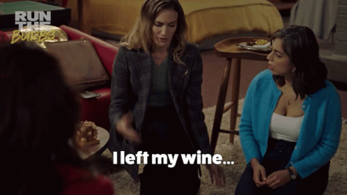 A Woman Says " I Left My Wine " While Sitting In A Living Room GIF