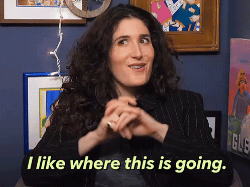 A Woman Says " I Like Where This Is Going " In Front Of Framed Pictures GIF