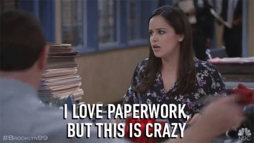 A Woman Says I Love Paperwork But This Is Crazy In Front Of A Pile Of Papers GIF