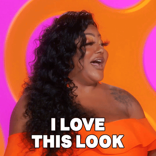 A Woman Says I Love This Look In Front Of A Pink And Orange Background GIF
