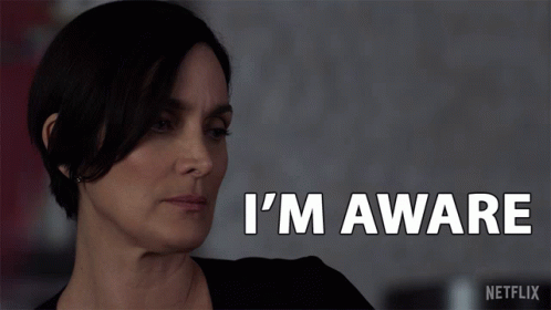 a woman says i 'm aware in white letters