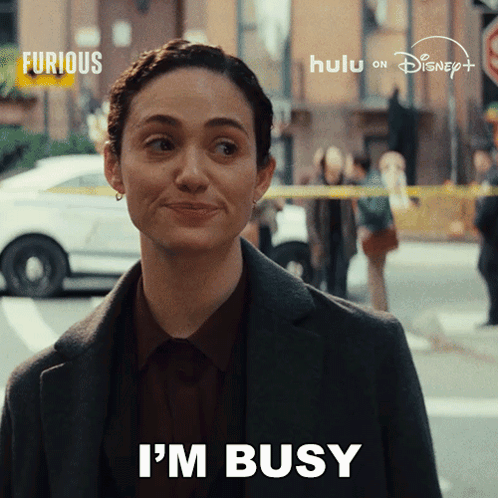 A Woman Says " I 'M Busy " In Front Of A Disney Logo GIF
