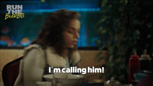 A Woman Says I 'M Calling Him While Sitting At A Table With A Bowl Of Food GIF