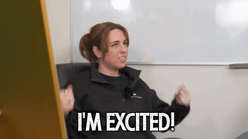 A Woman Says I 'M Excited In Front Of A Whiteboard GIF