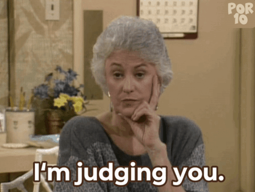 A Woman Says I 'M Judging You While Holding Her Hand To Her Chin GIF