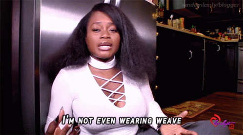 A Woman Says I 'M Not Even Wearing Weave In Front Of A Refrigerator GIF