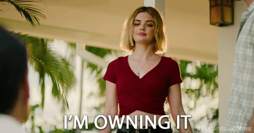 A Woman Says I 'M Owning It In A Red Shirt GIF