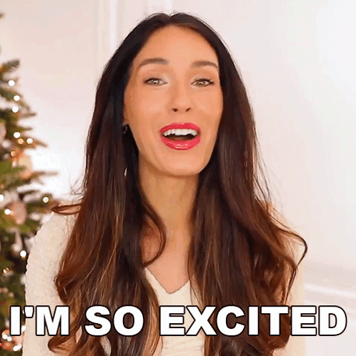 A Woman Says I 'M So Excited Next To A Christmas Tree GIF