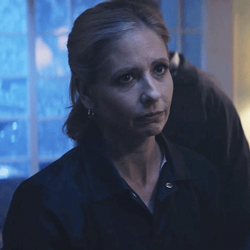 A Woman Says I 'M Sorry In Front Of A Blue Background GIF