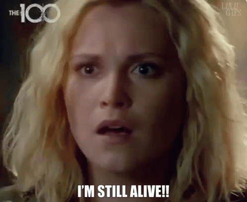A Woman Says I 'M Still Alive In Front Of A 100 Logo GIF
