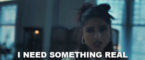 A Woman Says I Need Something Real In A Dark Room GIF