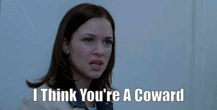 A Woman Says " I Think You 'Re A Coward " In Front Of A Door GIF
