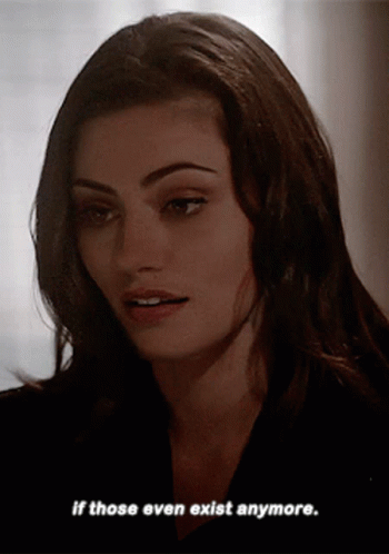 A Woman Says " If Those Even Exist Anymore " In A Dark Room GIF