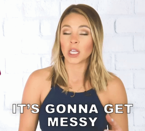 A Woman Says " It 'S Gonna Get Messy " In Front Of A White Brick Wall GIF
