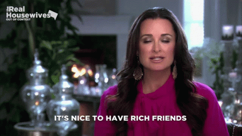 A Woman Says It 'S Nice To Have Rich Friends On A Screen GIF