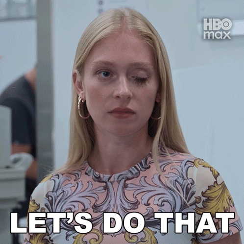A Woman Says Let 'S Do That In Front Of A White Wall GIF