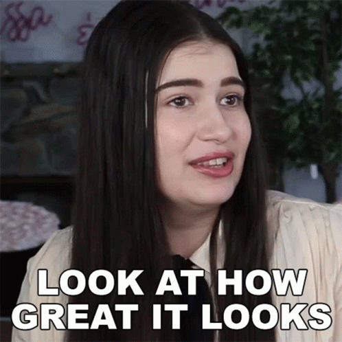 A Woman Says " Look At How Great It Looks " In White Letters GIF