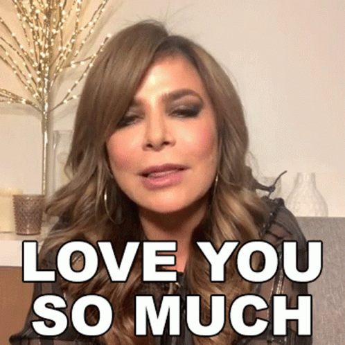 A Woman Says " Love You So Much " In Front Of A Vase GIF