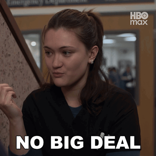 A Woman Says No Big Deal In Front Of A Hbo Max Sign GIF